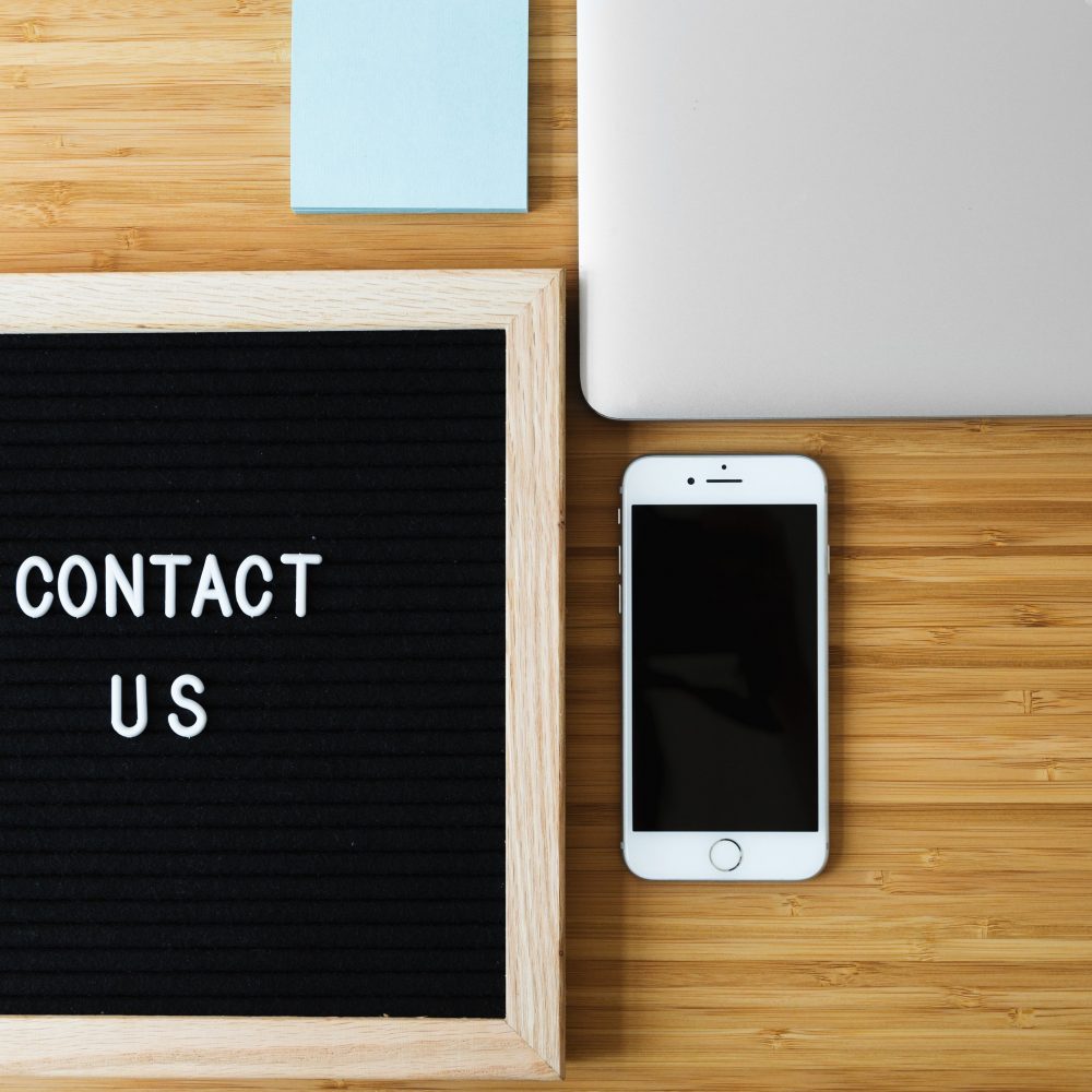 contact-us-sign-with-phone-on-desk_4460x4460